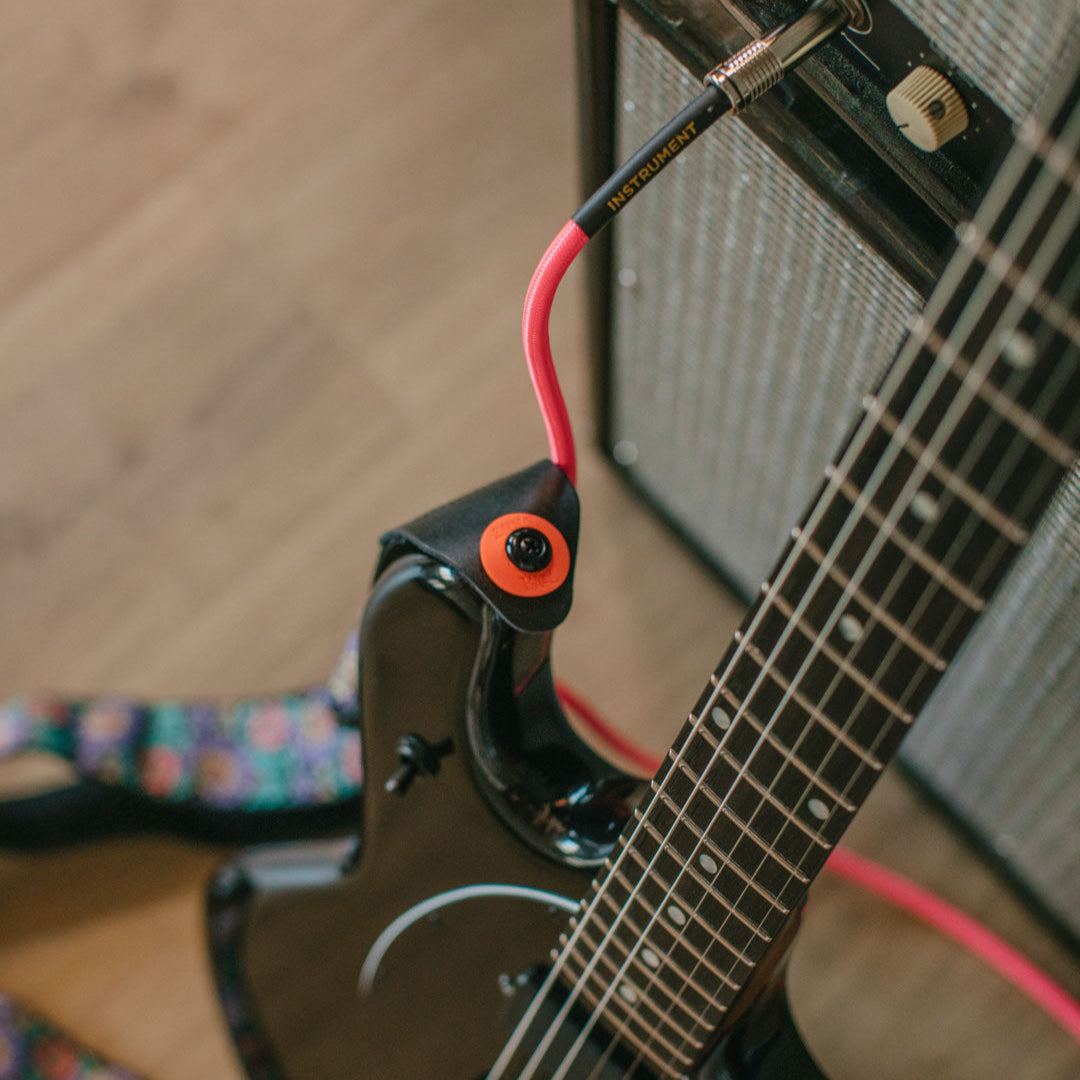 Ernie Ball Red & Black Strap Fastening Blocks - 4-Pack: Secure Your Instrument Now!